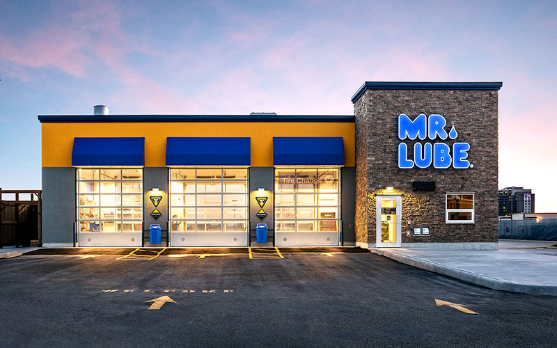 Mr. Lube automotive service building with three illuminated service bays