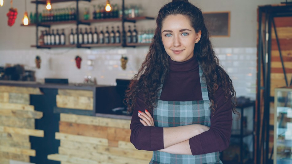 Illustrative portrait of a café operator standing in her coffee shop